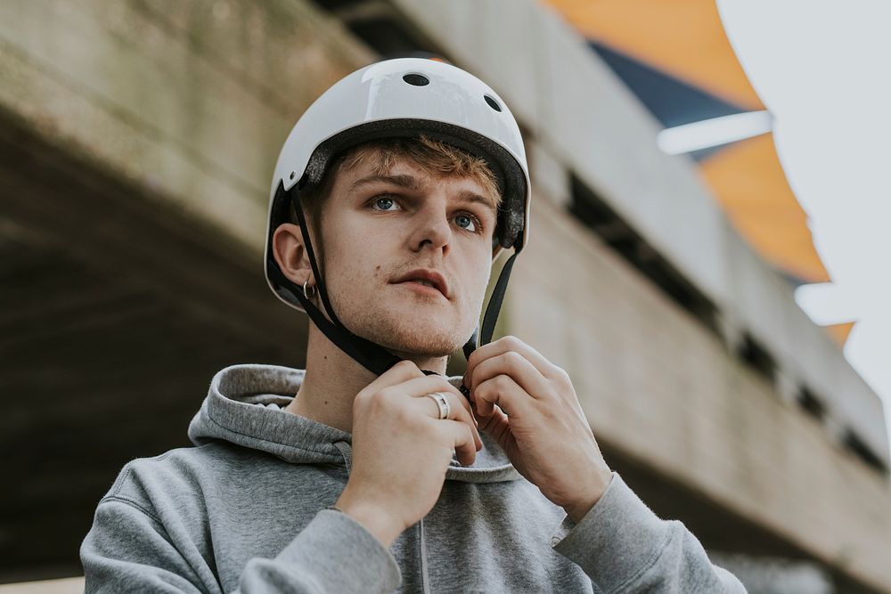 Man wearing white skate helmet for safety