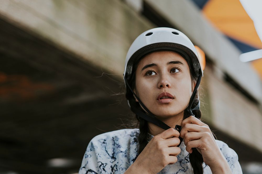 Woman wearing white skate helmet, sports safety equipment