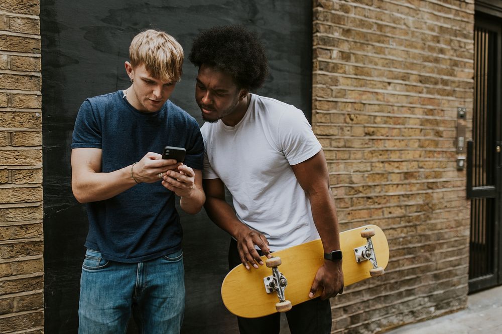Skaters using phone for direction in city