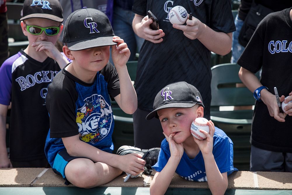 Young fans of the Colorado Rockies major-league baseball team wait and hope for player autographs at a Spring Training game…