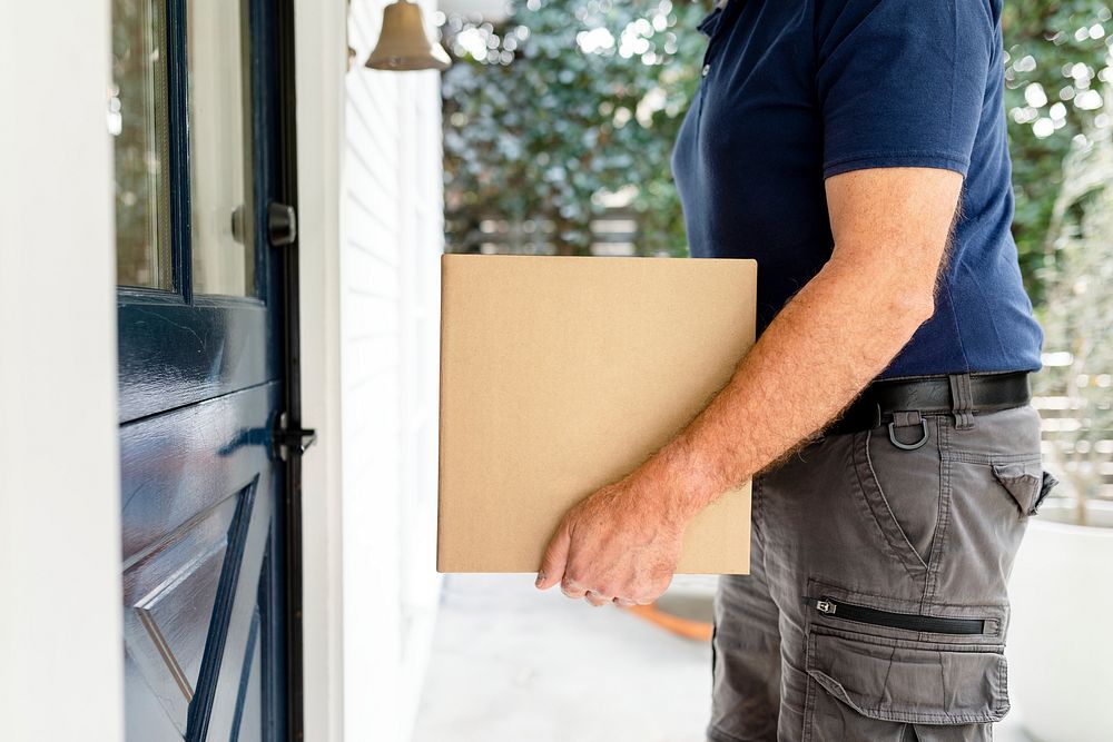 Package delivery service man holding a box image