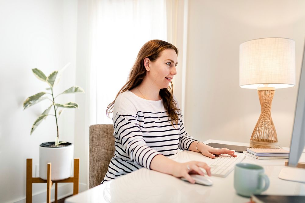 Woman using computer, working from home during the new normal