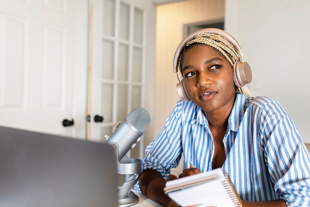 Black woman live streaming podcast session at home studio