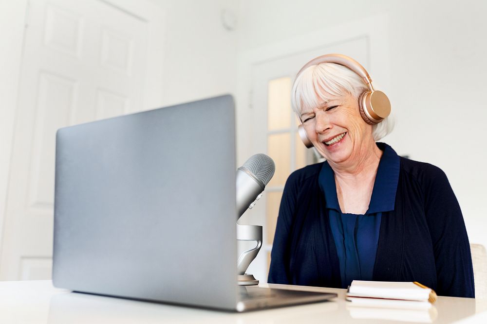 Senior woman live streaming podcast session at home studio