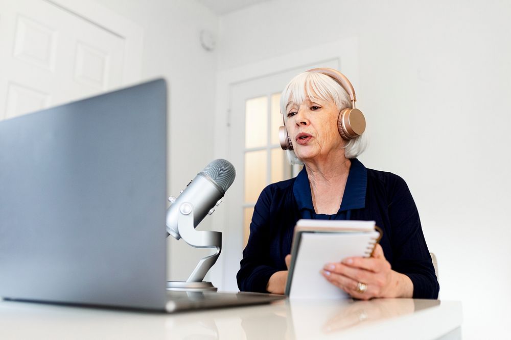 Successful woman hosting podcast streaming session at home