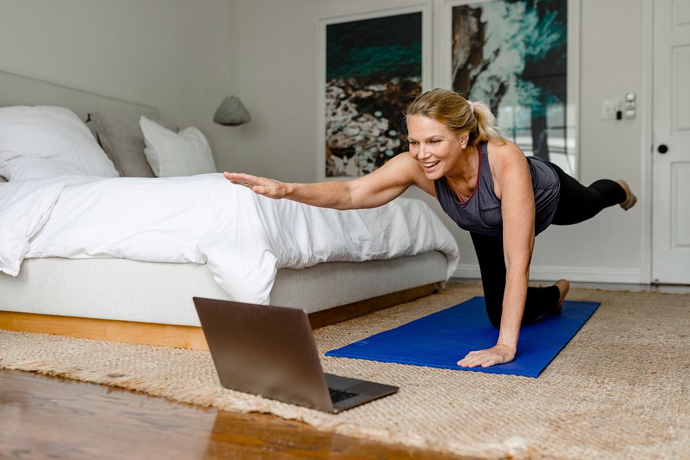 Woman in plank yoga pose, online exercise session