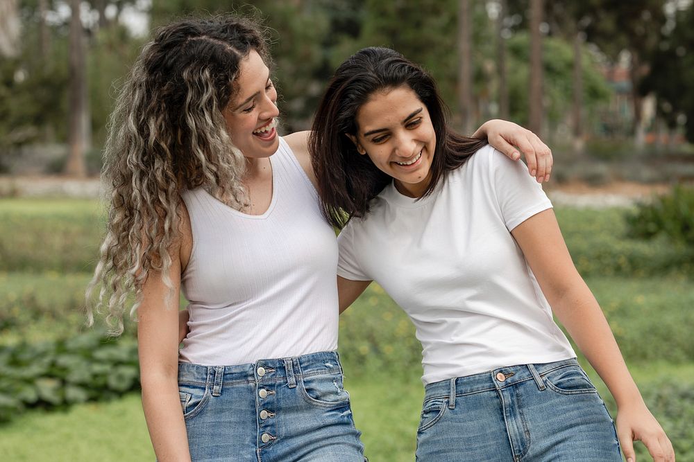 Friends in casual wear apparel, relaxing in a park