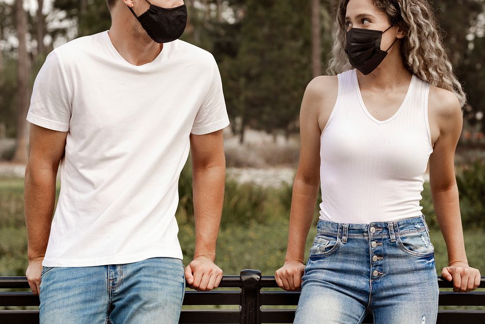 Couple wearing face masks, with physical distancing