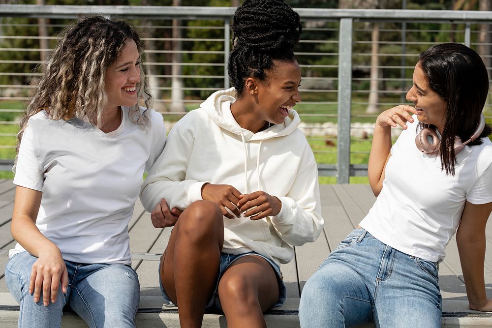 Diverse women in casual apparel, talking on steps