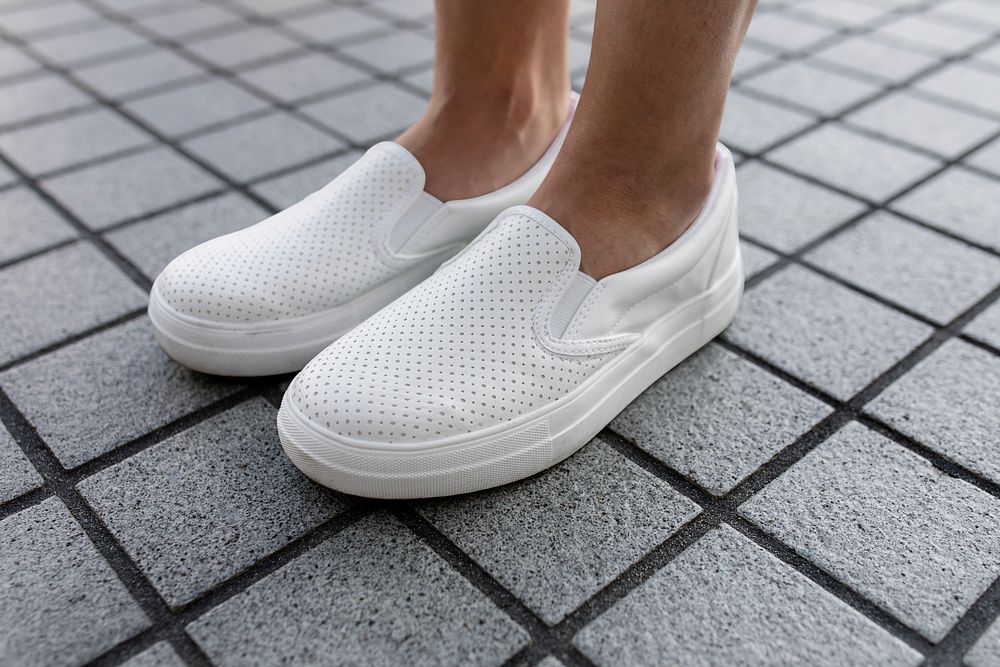 Plain white sneaker, women's footwear on a grey tiled floor