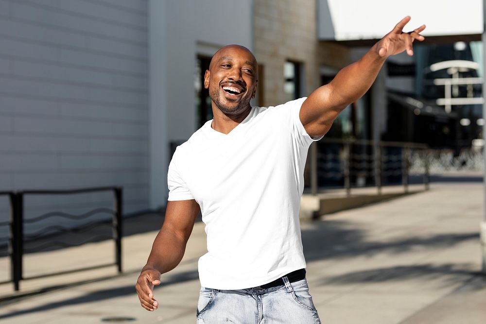 Happy African American man wearing plain white shirt, doing a greeting gesture