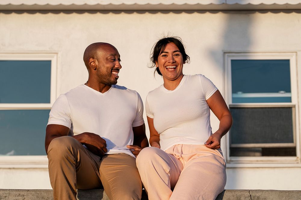 Couple enjoying dating in urban scene, wearing plain white shirts