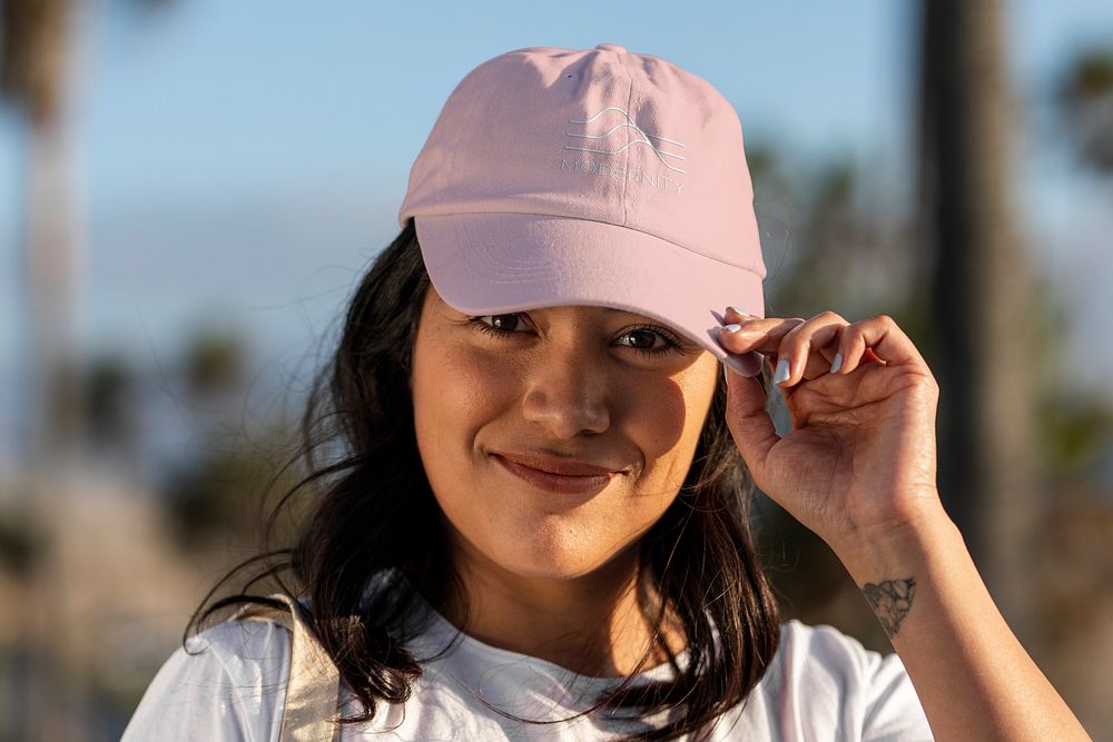 Pink cap mockup psd, Latina woman tipping her hat