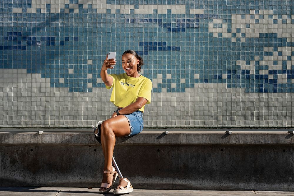 Happy disabled woman, shirt mockup psd, selfie pose in urban scene