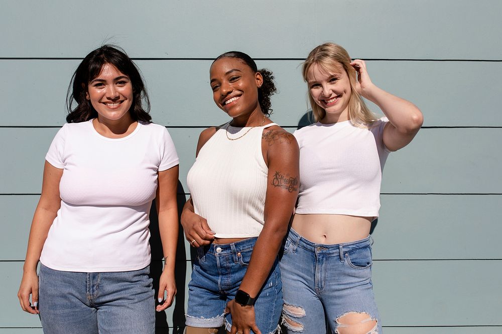Three mixed race girlfriends, confident women wearing plain white apparel