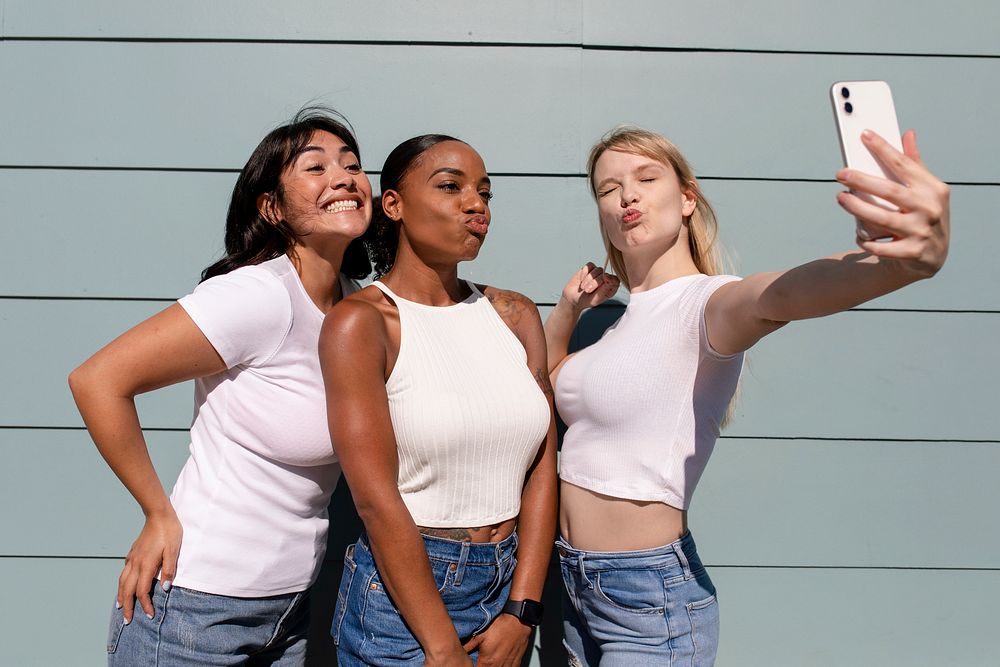 Beautiful diverse women taking a selfie, wearing plain white clothes