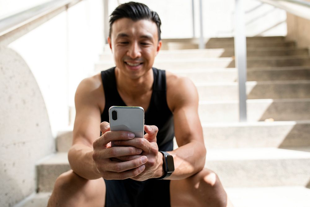 Happy Asian man using a smartphone 
