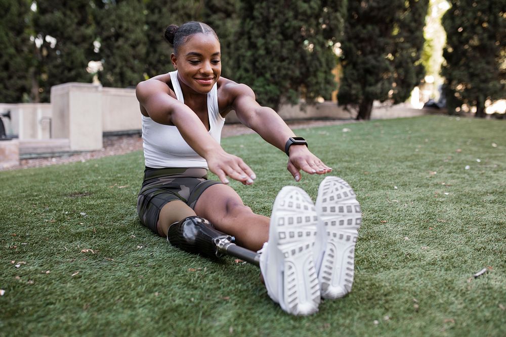 Woman with prosthetic leg stretching