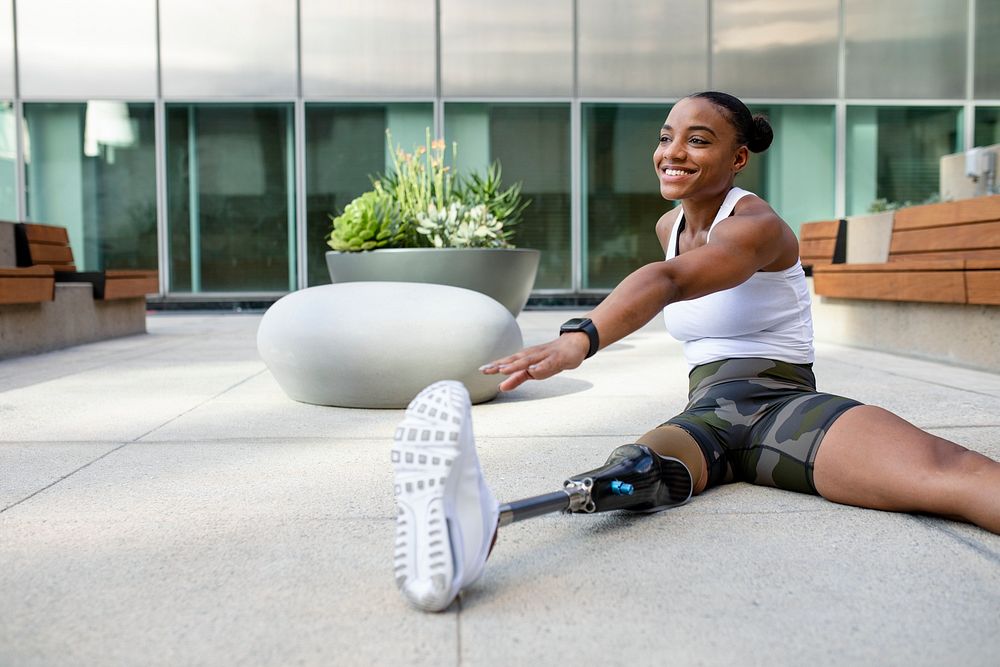 Woman with prosthetic leg stretching