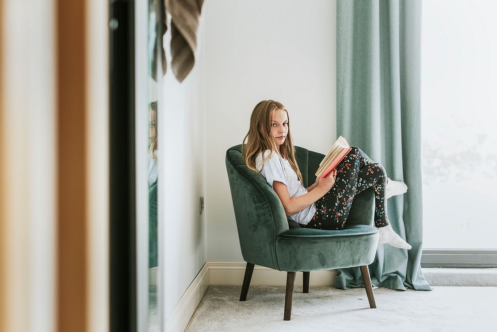 Girl reading a book on a couch, new normal hobby