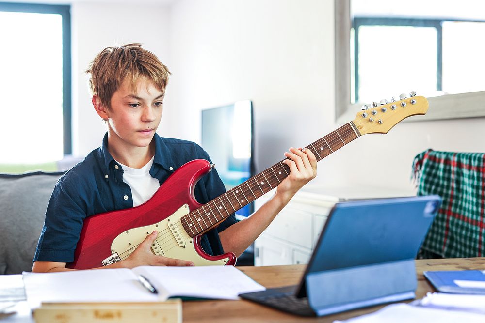 Blond boy having online class, homeschooling in the new normal