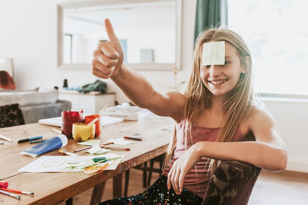 Sticky note on young girl forehead, homeschooling in the new normal