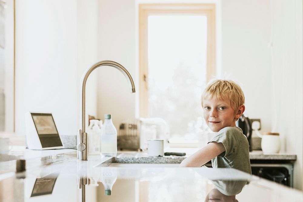 Boy washing dishes, household chores for kids