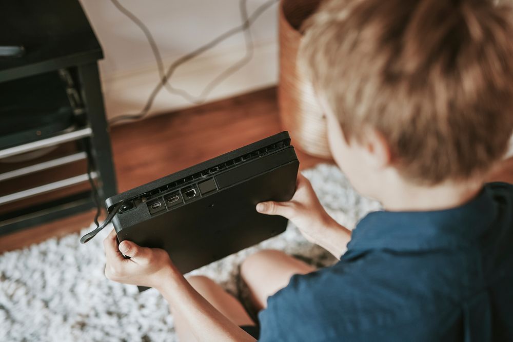 Boy holding video game console