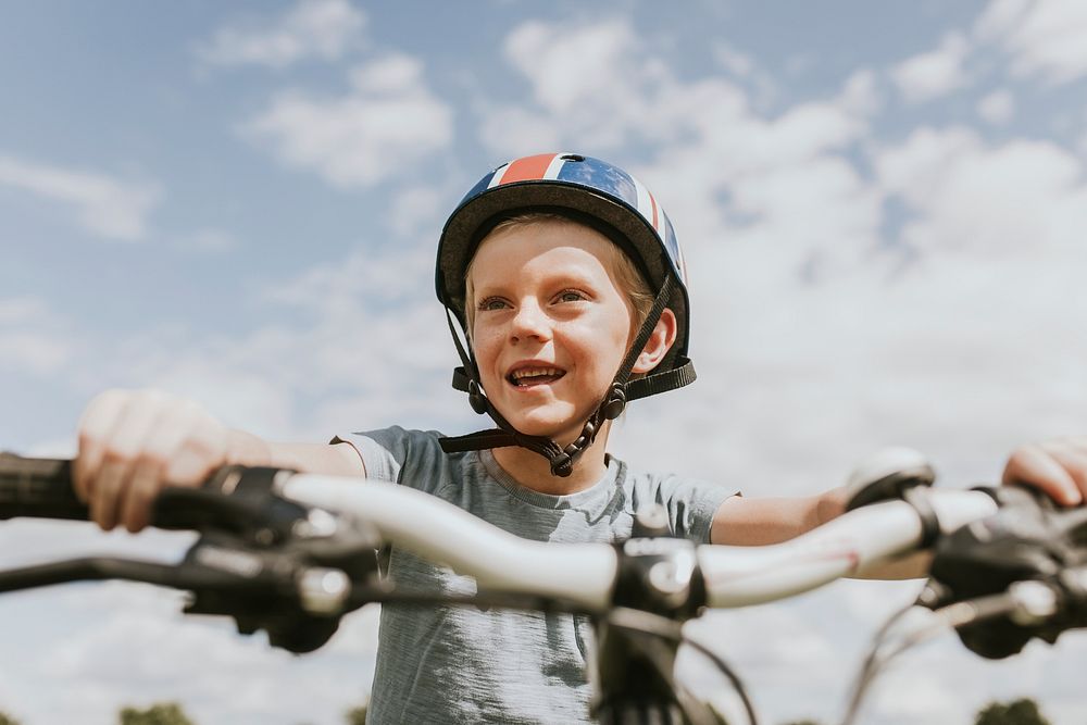 Kid&rsquo;s hobby background, boy riding a bike, summer hobby