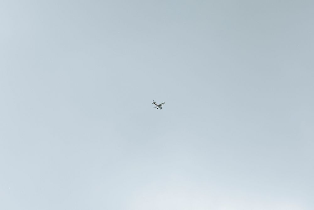 Sky background, airplane flying in the blue