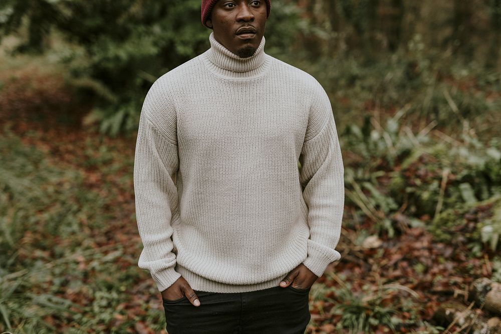 Man with white turtleneck sweater in forest