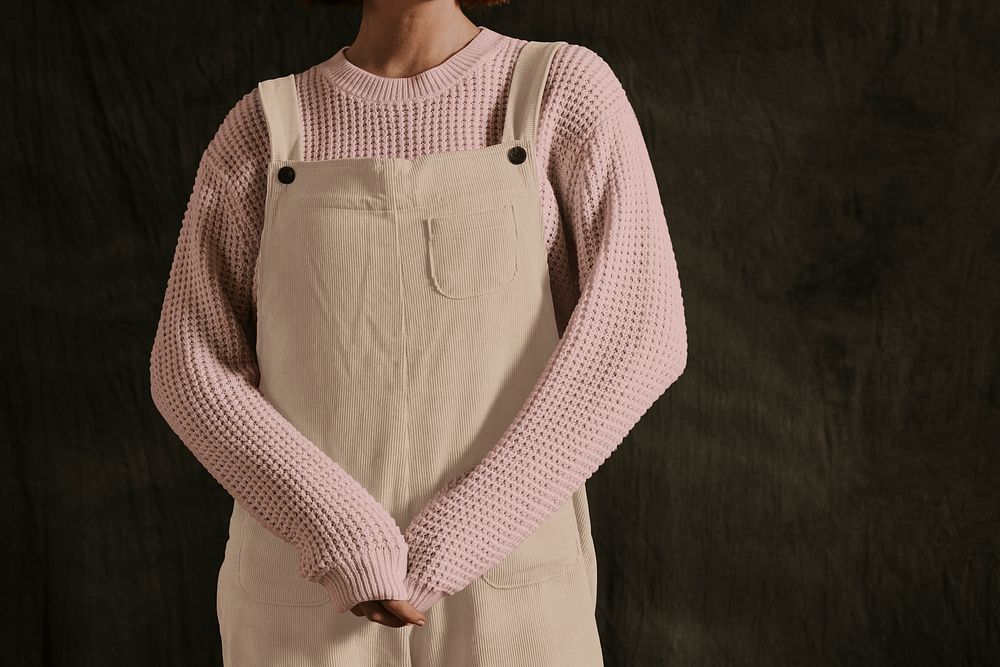 Woman in beige overall and pink jumper