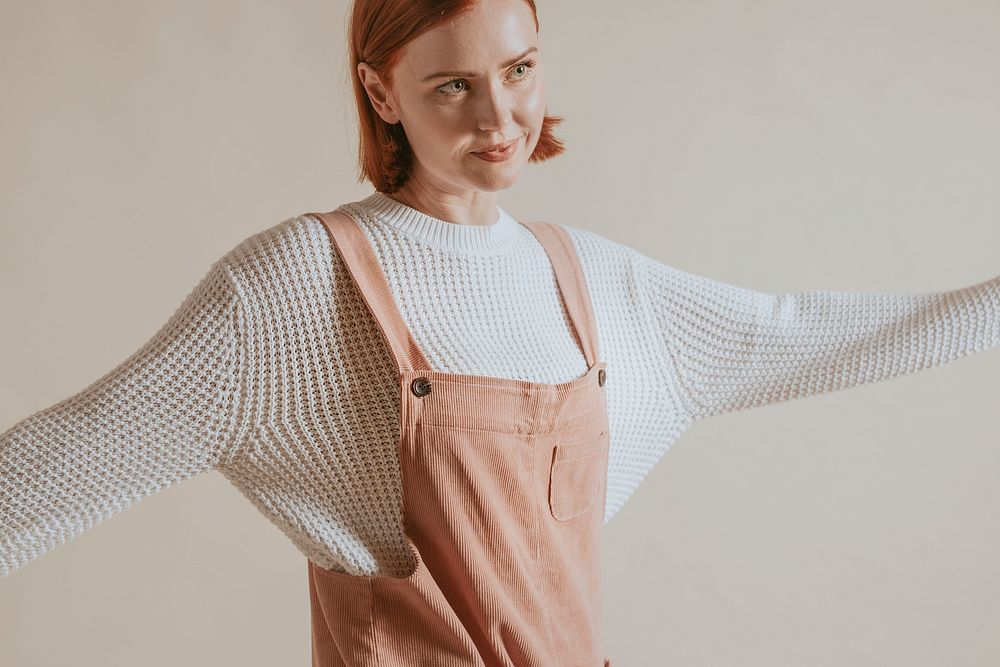 Woman wearing pink dungaree with white sweater