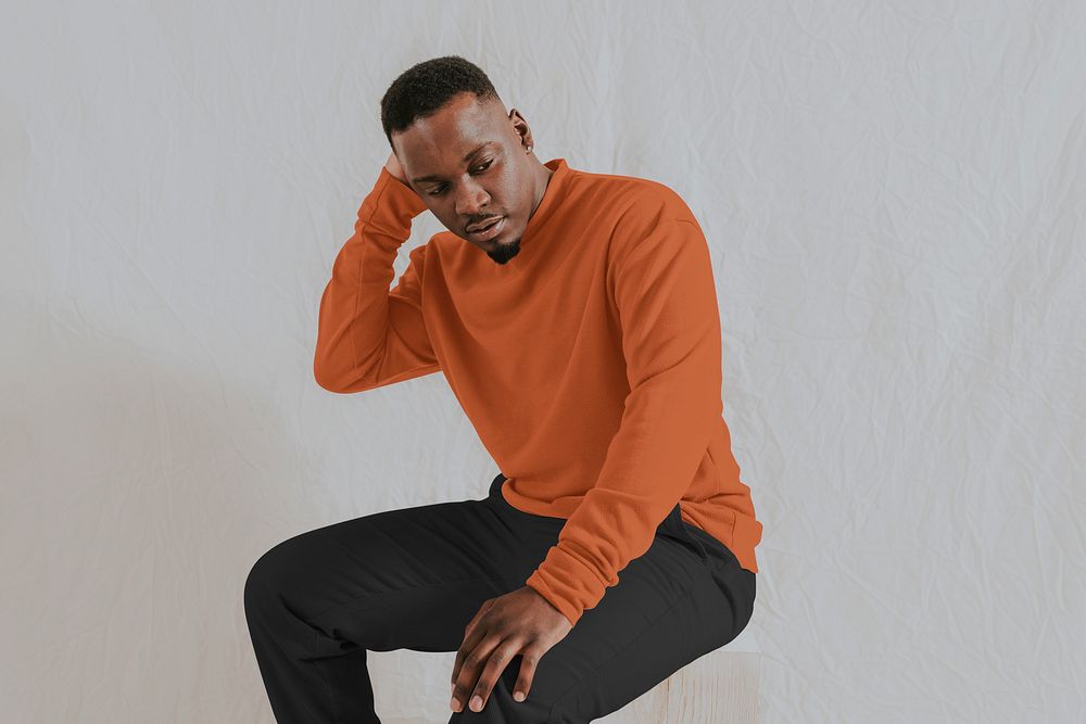 Man wearing orange long sleeve with black pants, autumn apparel fashion design
