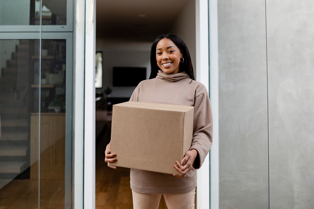 Woman receiving delivery package to her front door