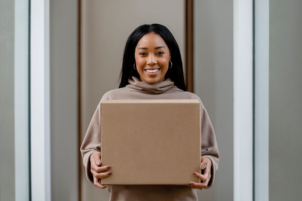 Happy woman receiving delivery package to her front door