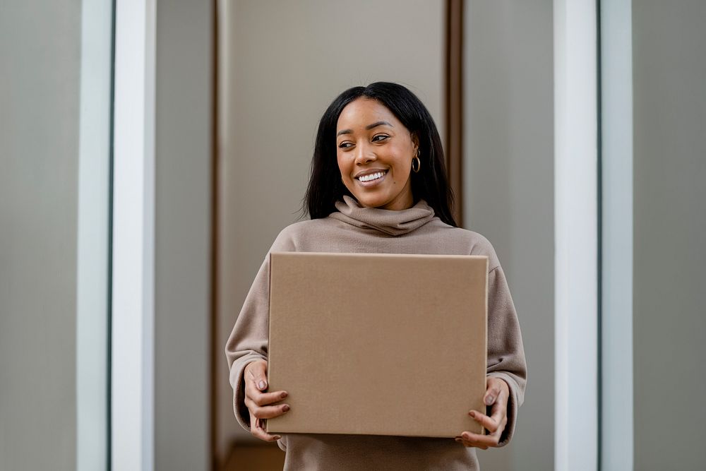 Woman receiving delivery package to her front door