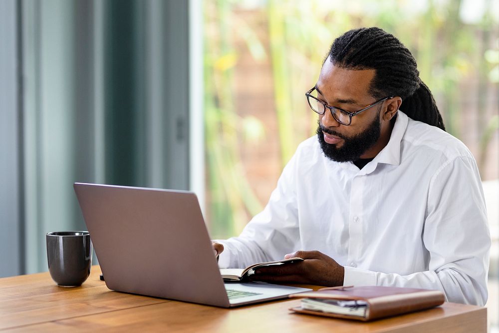 Cool businessman working from home on laptop
