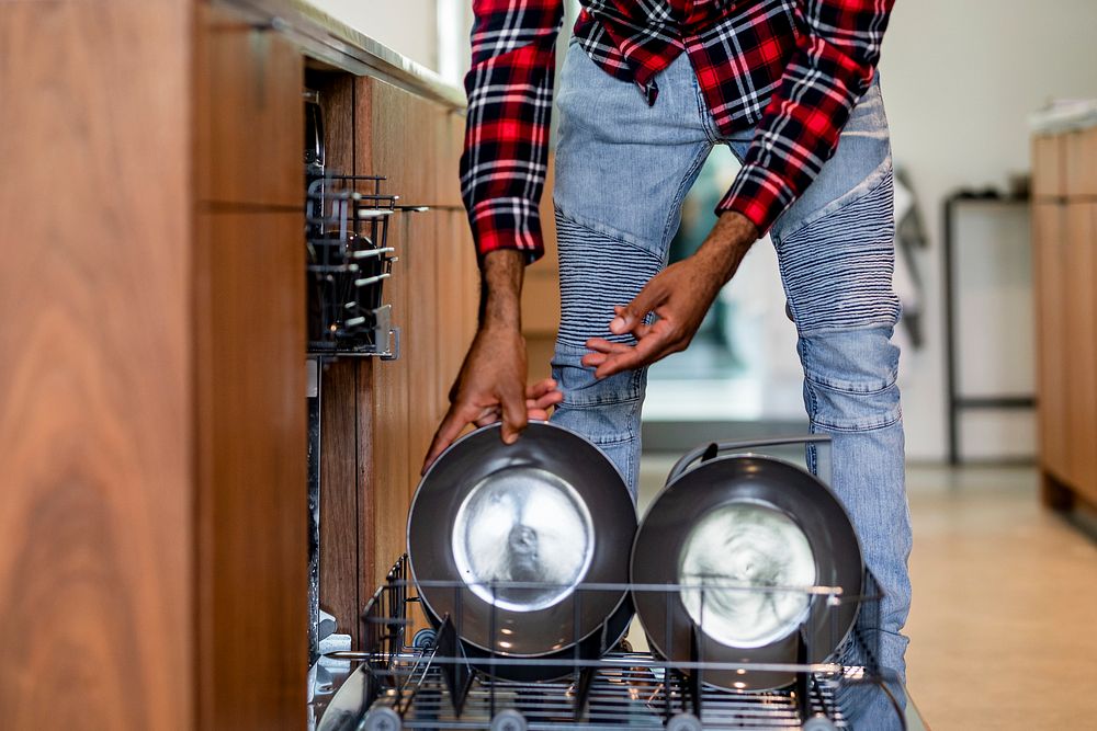 Putting dirty dishes into dishwasher, home chores