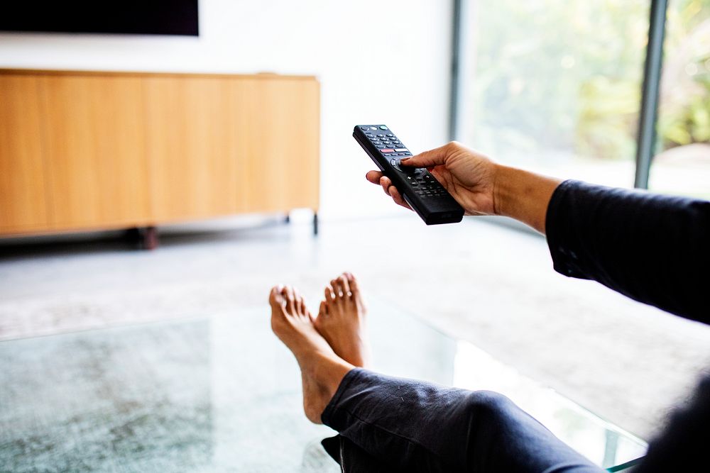 Woman relaxing at home in front of the TV