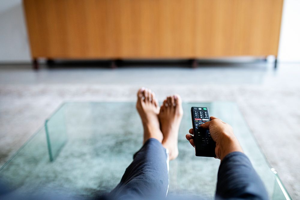 Woman relaxing at home in front of the TV