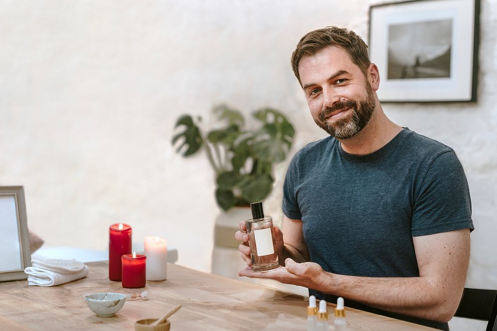 Man holding perfume bottle, massage & beauty photo
