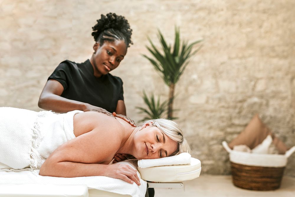 Woman getting back massage in spa, health & wellness photo