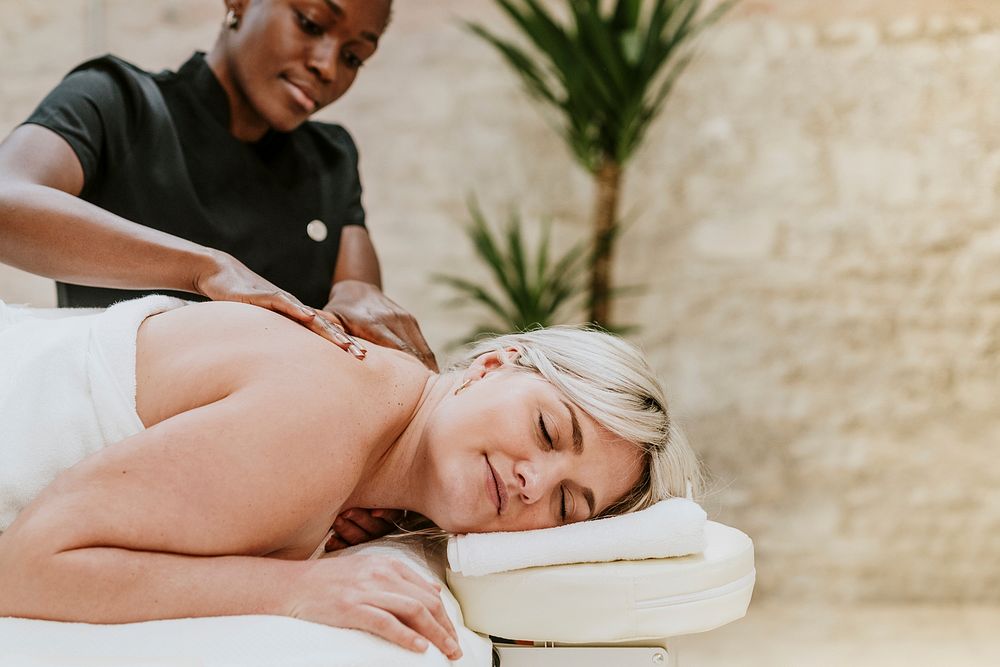 Woman getting massage in spa, health & wellness concept