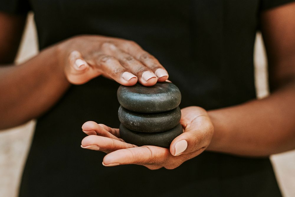 Woman holding spa stones for massage