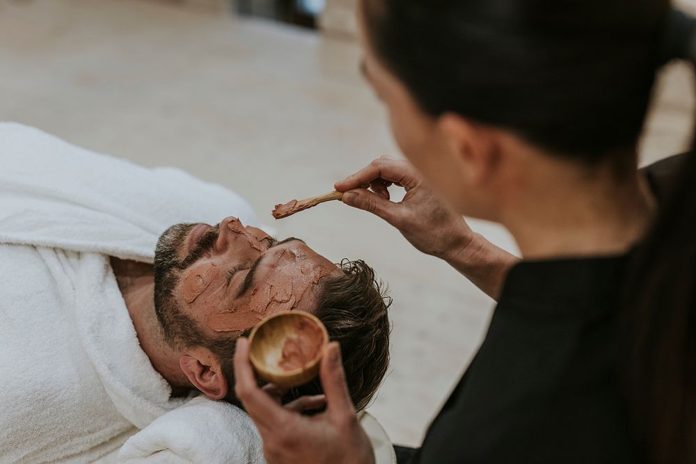 Man getting spa facial mask, self-care photo