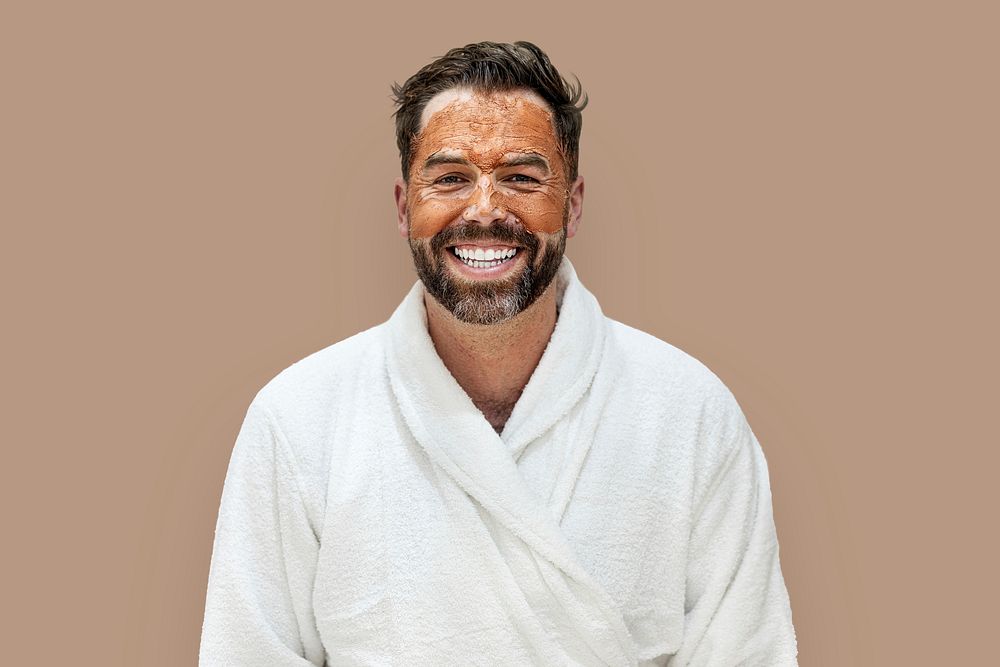 Man in bathrobe with facial mask 