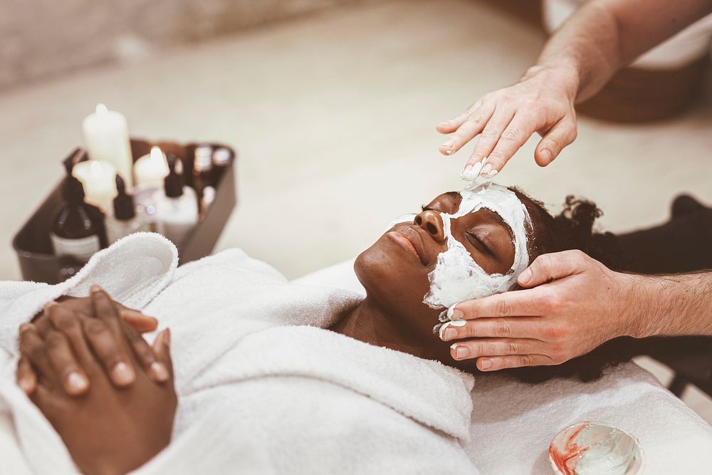 Woman getting spa face mask, relaxation photo