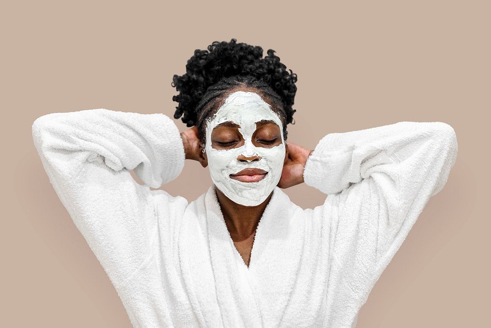African American woman with mud facial mask on her face