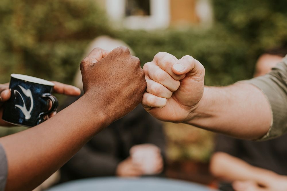 Friends fist bumping at a party 